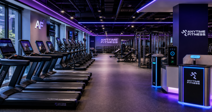 A modern Anytime Fitness gym interior in 2026 with purple ambient lighting and high-tech fitness equipment.