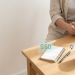 Minimal workspace with smartphone, notebook and coffee representing starting a business with low budget.